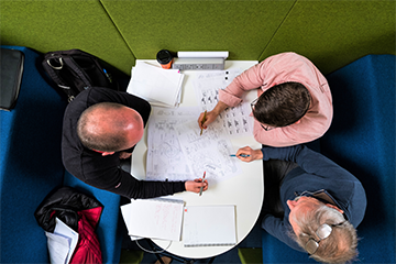 people looking at paperwork at desk